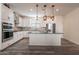 Modern kitchen with white cabinets, granite island, and stainless steel appliances at 5172 E Desert Forest Trl, Cave Creek, AZ 85331