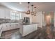 Modern kitchen with white cabinets, granite island, and stainless steel appliances at 5172 E Desert Forest Trl, Cave Creek, AZ 85331