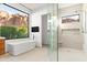 Bright bathroom featuring a glass shower, soaking tub and mountain view at 5724 N Echo Canyon Dr, Phoenix, AZ 85018