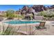 View of the community pool with lounge chairs, desert landscaping, and Echo Canyon mountains in the background at 5724 N Echo Canyon Dr, Phoenix, AZ 85018