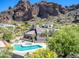 An aerial shot showcases the community pool and spa nestled amidst desert landscaping with Echo Canyon mountains in the background at 5724 N Echo Canyon Dr, Phoenix, AZ 85018