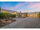 Beautiful home exterior showcasing a spacious paver driveway, desert landscaping and a three-car garage at 5724 N Echo Canyon Dr, Phoenix, AZ 85018