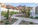 Lush desert landscaping and an inviting walkway, lead to the front entrance of this stylish desert home at 5724 N Echo Canyon Dr, Phoenix, AZ 85018