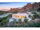 Aerial view of a modern white home featuring a private pool and spectacular mountain views in the background at 5724 N Echo Canyon Dr, Phoenix, AZ 85018