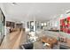 Open-concept living room with modern decor, wood floors, and seamless flow to the kitchen area at 5724 N Echo Canyon Dr, Phoenix, AZ 85018