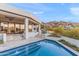 An inviting pool area with an outdoor dining area, landscaping and scenic mountain views at 5724 N Echo Canyon Dr, Phoenix, AZ 85018