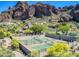 Aerial view of the community tennis courts with desert landscaping and views of Echo Canyon mountains in the background at 5724 N Echo Canyon Dr, Phoenix, AZ 85018