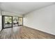 Bright living room with hardwood floors and sliding glass doors leading to a balcony at 6125 E Indian School Rd # 218, Scottsdale, AZ 85251