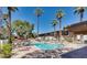 Sparkling community pool with ample lounge chairs and patio umbrellas at 6125 E Indian School Rd # 218, Scottsdale, AZ 85251