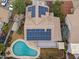 House with solar panels and kidney-shaped pool, seen from above at 629 E Palo Verde St, Casa Grande, AZ 85122