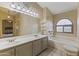 Bathroom boasts double sinks, a soaking tub, and a large mirror at 629 E Palo Verde St, Casa Grande, AZ 85122