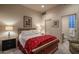 Cozy bedroom with a red floral comforter and en-suite bathroom at 7073 E Brilliant Sky Dr, Scottsdale, AZ 85266