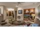 Living room with fireplace and built-in entertainment center at 7073 E Brilliant Sky Dr, Scottsdale, AZ 85266