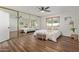 Spacious bedroom with mirrored closet doors and wood flooring at 7638 E Northland Dr, Scottsdale, AZ 85251