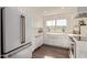 Bright white kitchen features stainless steel appliances and wood shelving at 7638 E Northland Dr, Scottsdale, AZ 85251