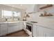 Renovated kitchen boasts white shaker cabinets and marble countertops at 7638 E Northland Dr, Scottsdale, AZ 85251