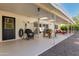 Covered patio with rocking chair and dining area, offering a tranquil setting at 7638 E Northland Dr, Scottsdale, AZ 85251