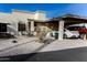 Front view of a stucco home with carport, small patio, and landscaped yard at 7708 E Park View Dr Dr, Mesa, AZ 85208