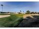 View of a lush green golf course with sand traps and palm trees at 7708 E Park View Dr Dr, Mesa, AZ 85208