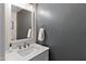 Modern bathroom with white vanity and gray textured walls at 8147 W Hilton Ave, Phoenix, AZ 85043