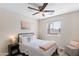 Bright bedroom with a queen bed, nightstands, and a ceiling fan at 8147 W Hilton Ave, Phoenix, AZ 85043