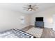 Bedroom with large window, ceiling fan, and dresser at 8147 W Hilton Ave, Phoenix, AZ 85043