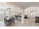 Open concept dining area with a large table and chairs, adjacent to the living room at 8147 W Hilton Ave, Phoenix, AZ 85043