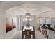 Formal dining room with dark wood table and chairs, adjacent to living room at 8147 W Hilton Ave, Phoenix, AZ 85043