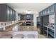 Modern kitchen with gray cabinets and granite countertops at 8147 W Hilton Ave, Phoenix, AZ 85043