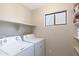 Laundry room with washer, dryer, and shelving at 8147 W Hilton Ave, Phoenix, AZ 85043