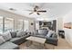 Spacious living room with gray sectional sofa and view of kitchen at 8147 W Hilton Ave, Phoenix, AZ 85043