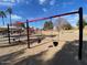 Four-swing set at a sandy playground at 8147 W Hilton Ave, Phoenix, AZ 85043