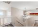 Elegant upstairs hallway with chandelier and hardwood floors at 8147 W Hilton Ave, Phoenix, AZ 85043