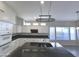 Modern kitchen featuring white cabinets and black granite countertops at 854 W Mesquite St, Gilbert, AZ 85233