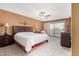 Main bedroom with king-size bed, ceiling fan, and access to balcony at 9183 W Century Dr, Arizona City, AZ 85123