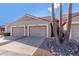 Tan two-story stucco home with two-car garage and desert landscaping at 9183 W Century Dr, Arizona City, AZ 85123