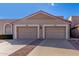 Front view of two-car garage and tan stucco home at 9183 W Century Dr, Arizona City, AZ 85123