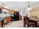 Kitchen with wood cabinets, black appliances, and granite counters at 9183 W Century Dr, Arizona City, AZ 85123