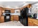 Spacious kitchen with ample wood cabinets, black appliances, and tile flooring at 9183 W Century Dr, Arizona City, AZ 85123