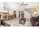 Open living and dining area with fireplace, tiled floors, and stairs at 9183 W Century Dr, Arizona City, AZ 85123