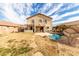 The backyard features pool with a rock grotto, lake view, and covered patio at 11163 W Edgemont Ave, Avondale, AZ 85392