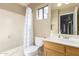 Bathroom boasts shower-tub, single sink vanity, and ample lighting at 11163 W Edgemont Ave, Avondale, AZ 85392