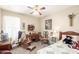 Comfortable bedroom featuring a plush bed, vintage furnishings, and a ceiling fan at 11163 W Edgemont Ave, Avondale, AZ 85392