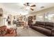 Open-concept living area with a comfortable leather sofa, ceiling fan, and seamless flow to the kitchen at 11163 W Edgemont Ave, Avondale, AZ 85392