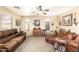 Inviting living room featuring plush leather sofas, neutral tones, and a ceiling fan for comfortable living at 11163 W Edgemont Ave, Avondale, AZ 85392