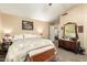Comfortable main bedroom featuring a plush bed, vintage furnishings, and a ceiling fan at 11163 W Edgemont Ave, Avondale, AZ 85392