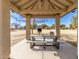 A covered pavilion with a picnic table and barbeque grill in a community park, perfect for outdoor gatherings at 11163 W Edgemont Ave, Avondale, AZ 85392