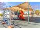 Vibrant community playground with climbing structures, slides and swings under a shaded canopy, for active fun at 11163 W Edgemont Ave, Avondale, AZ 85392