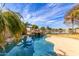Backyard oasis with a refreshing pool, rock grotto, and waterfront view at 11163 W Edgemont Ave, Avondale, AZ 85392