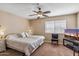 Main bedroom with ceiling fan, large windows and TV at 11333 N 92Nd St # 2035, Scottsdale, AZ 85260